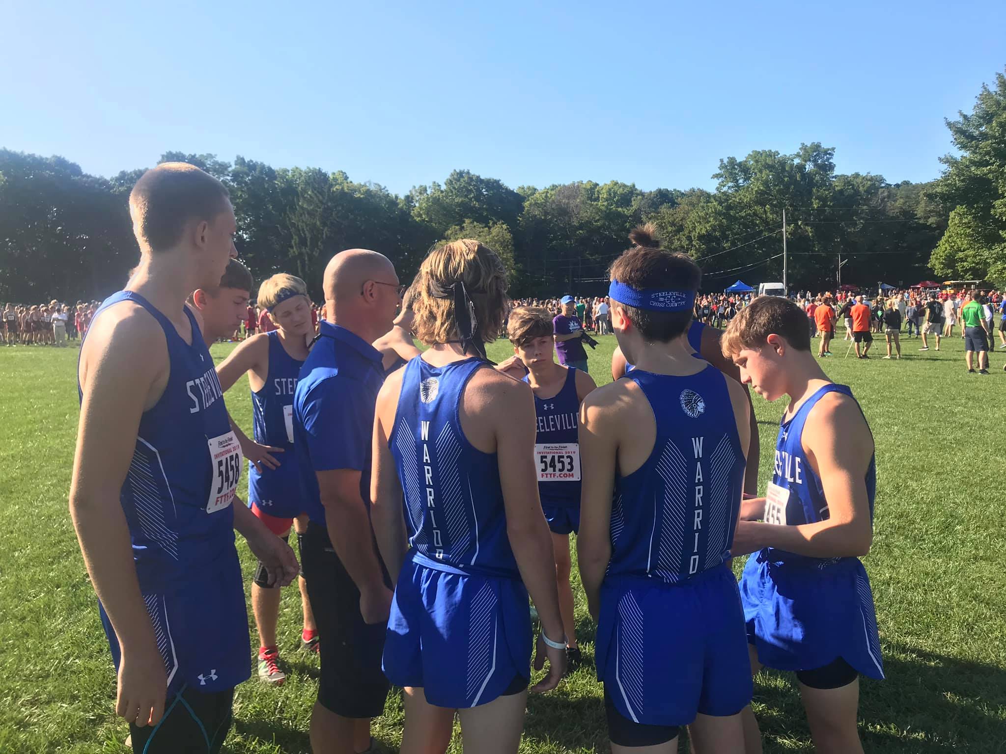 Coach Neal Haertling giving the boys cross country team a pre race talk on September 14, 2019 at Peoria.
